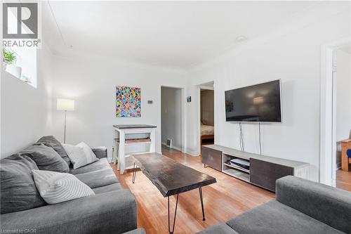 Living area featuring wood-finish flooring, white walls, and a recessed window - 58 Edinburgh Avenue, Hamilton, ON - Indoor Photo Showing Living Room