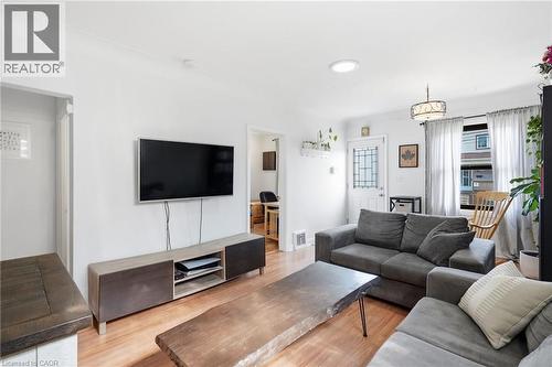 Living space featuring wood-finish flooring, white walls, and a recessed ceiling light - 58 Edinburgh Avenue, Hamilton, ON - Indoor Photo Showing Living Room