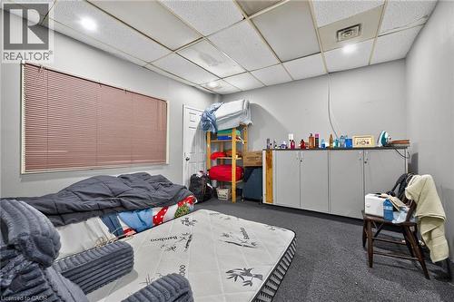 Room featuring gray walls, a window with horizontal blinds, and a textured drop ceiling - 1292 Barton Street E, Hamilton, ON 