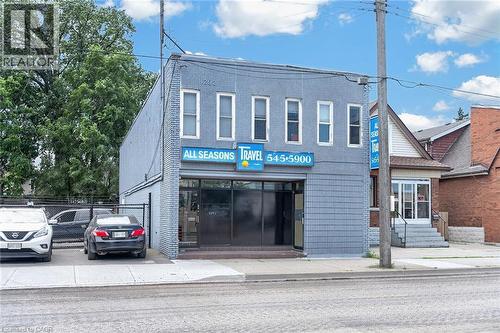 Two-story commercial building featuring a stucco upper facade and a brick lower level - 1292 Barton Street E, Hamilton, ON 