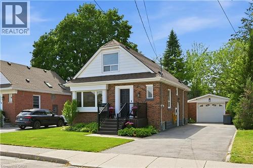 Brick exterior home with white siding accents and a pitched roof - 18 Ipswich Place, Hamilton, ON - Outdoor