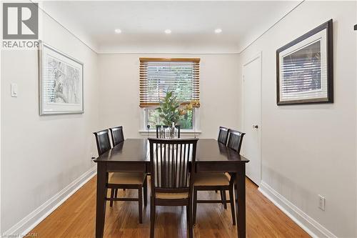 Hardwood flooring complemented by recessed lighting and a window with wood-finish blinds - 18 Ipswich Place, Hamilton, ON - Indoor Photo Showing Dining Room