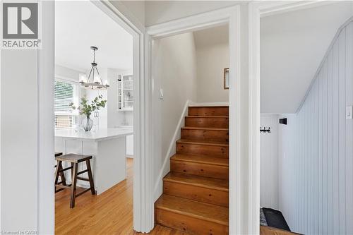Hardwood staircase and plank-paneled wall detail - 18 Ipswich Place, Hamilton, ON - Indoor Photo Showing Other Room