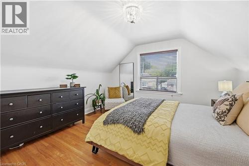 Room featuring hardwood flooring, sloped ceilings, and a window with blinds - 18 Ipswich Place, Hamilton, ON - Indoor Photo Showing Bedroom