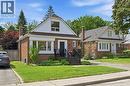 Brick exterior with white siding accents and a dormer window - 18 Ipswich Place, Hamilton, ON  - Outdoor With Facade 