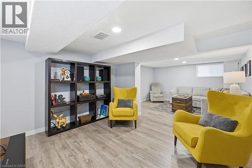 Finished lower level featuring recessed lighting, light-toned walls, and wood-finish flooring - 18 Ipswich Place, Hamilton, ON - Indoor