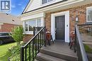 Brick exterior with white trim accents and a black paneled front door - 18 Ipswich Place, Hamilton, ON  - Outdoor With Deck Patio Veranda With Exterior 