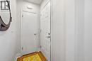 Entryway featuring wood-finish flooring, a white paneled door, and a built-in overhead light fixture - 18 Ipswich Place, Hamilton, ON  - Indoor Photo Showing Other Room 