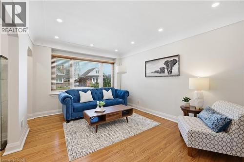 Living area featuring wood-finish flooring, recessed lighting, and an arched doorway - 18 Ipswich Place, Hamilton, ON - Indoor Photo Showing Living Room