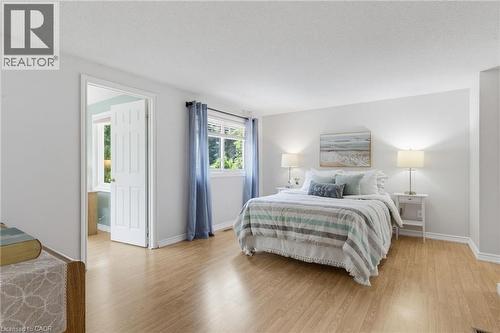 Spacious sleeping area featuring  light-toned walls, and multiple windows with natural light - 2188 Bader Crescent, Burlington, ON - Indoor Photo Showing Bedroom