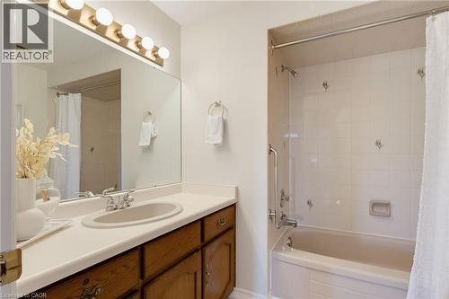 Bathroom featuring a wood-finish vanity with a single basin sink and expansive countertop - 2188 Bader Crescent, Burlington, ON - Indoor Photo Showing Bathroom