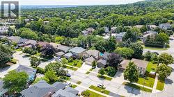 Aerial perspective showcasing residential properties with established landscaping and tree-lined streets - 