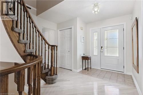 Gracious entryway featuring a curved open wooden staircase with carpeted treads - 2188 Bader Crescent, Burlington, ON - Indoor Photo Showing Other Room