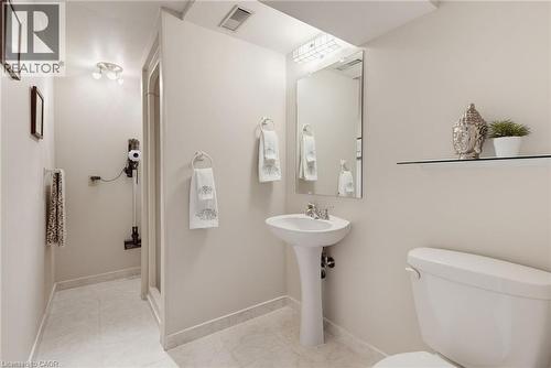 Bathroom featuring a pedestal sink, wall-mounted mirror, and shower enclosure - 2188 Bader Crescent, Burlington, ON - Indoor Photo Showing Bathroom