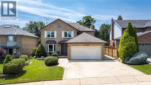 Traditional brick exterior with a large two-car garage - 2188 Bader Crescent, Burlington, ON - Outdoor With Facade
