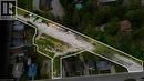 Expansive undeveloped land parcel outlined in white, featuring a substantial gravel area and bordering a wooded hillside - 9 James Street, Simcoe, ON 
