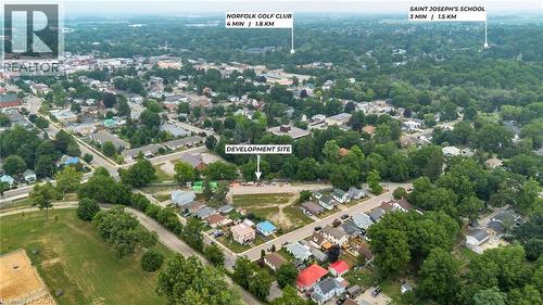 Aerial overview of a development site with surrounding residential properties and abundant mature trees - 9 James Street, Simcoe, ON 