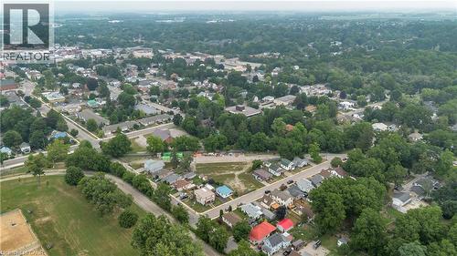 Aerial overview of a residential area characterized by mature tree cover and a mix of housing styles - 9 James Street, Simcoe, ON 