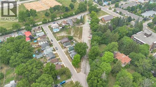 Aerial perspective showcasing a residential street with detached homes and abundant mature trees - 9 James Street, Simcoe, ON 