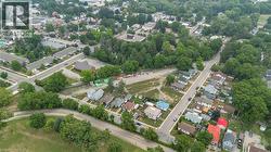 Aerial perspective showcasing a residential area with varied housing styles and mature tree coverage - 