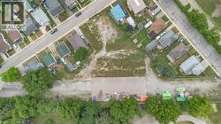 Expansive cleared lot with surrounding residential properties and mature trees - 