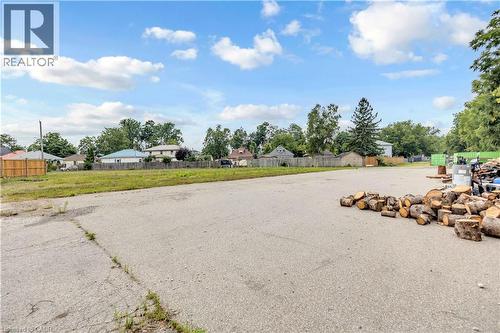 Expansive paved lot with visible grass areas - 9 James Street, Simcoe, ON 
