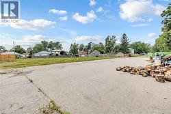 Expansive paved lot with visible grass areas - 