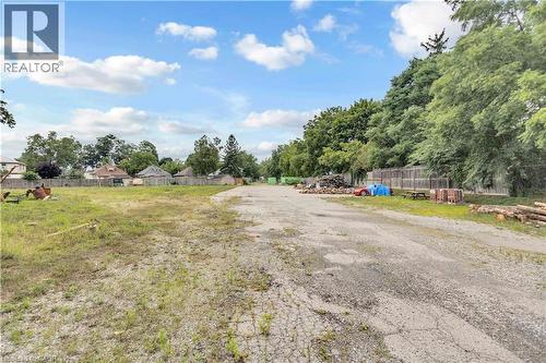 Expansive open lot featuring a combination of gravel and grassy areas - 9 James Street, Simcoe, ON 