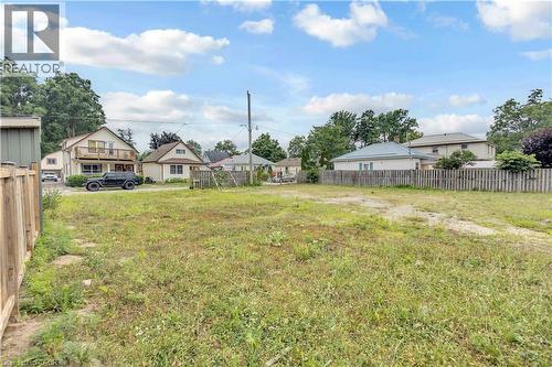 Cleared lot with partial wooden fence borders and mixed ground cover - 9 James Street, Simcoe, ON 