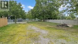 Expansive lot with a combination of gravel and grassy areas - 
