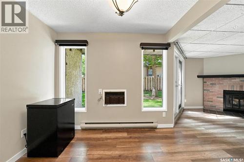 102 431 Tait Court, Saskatoon, SK - Indoor Photo Showing Other Room With Fireplace