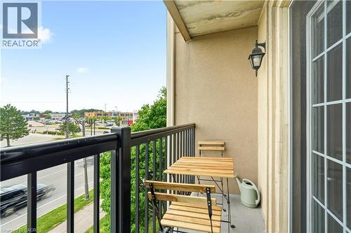 Private balcony featuring a black metal railing and a stucco exterior - 2035 Appleby Line Unit# 307, Burlington, ON - Outdoor With Balcony With Exterior