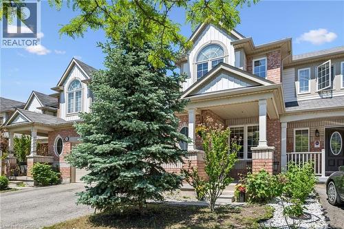 Brick and siding exterior featuring a covered front porch with decorative columns - 36 Van Fleet Terrace, Milton, ON - Outdoor With Facade