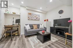 Living space featuring recessed lighting, wood-finish flooring, and a built-in shelf - 