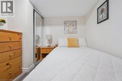Compact room featuring light-toned walls and wood-finish flooring - 
