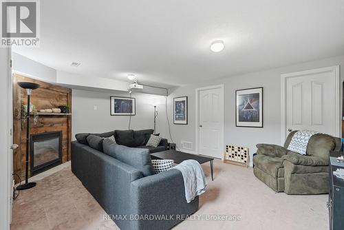 Recroom features a corner fireplace! - 617 Spikemoss Place, Ottawa, ON - Indoor Photo Showing Living Room With Fireplace