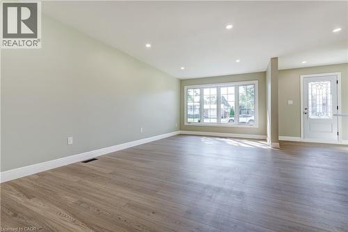Spacious interior featuring wood-finish flooring, recessed lighting, and light-toned wall paint - 191 Glenmor Drive, Caledonia, ON - Indoor Photo Showing Other Room
