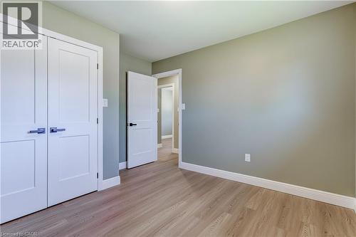 Light wood-finish flooring complemented by white baseboards - 191 Glenmor Drive, Caledonia, ON - Indoor Photo Showing Other Room