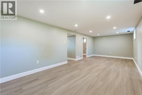 Spacious open area featuring recessed lighting, light wood-finish flooring, and light-toned walls with white baseboards - 191 Glenmor Drive, Caledonia, ON - Indoor