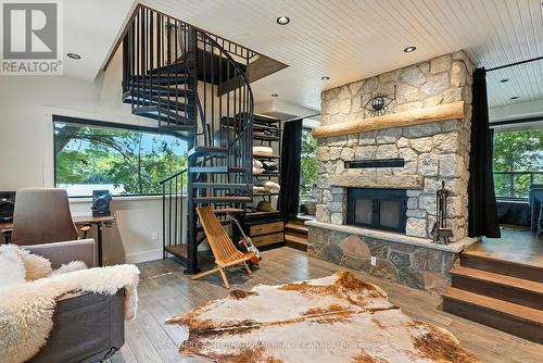 Stairs to loft - 1023 Mccabe Road, Lake Of Bays, ON - Indoor Photo Showing Living Room With Fireplace