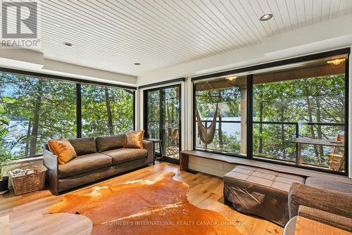 deck overlooks lake - 1023 Mccabe Road, Lake Of Bays, ON - Indoor Photo Showing Living Room