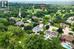 Aerial perspective showcasing a residential neighborhood with ample tree coverage - 