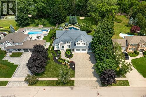 Spacious property featuring a large residence with a multi-car driveway and an in-ground swimming pool - 44 St Andrew'S Drive, Brantford, ON - Outdoor With In Ground Pool