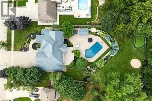 Expansive property featuring a large residence with a multi-gabled roof, an irregular-shaped pool, a putting green, a sand trap, and extensive landscaping - 44 St Andrew'S Drive, Brantford, ON - Outdoor With View