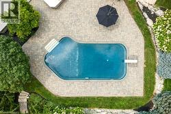 Geometric swimming pool featuring an integrated diving board and wide entry steps - 
