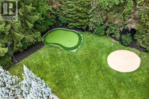 Expansive green lawn featuring a private putting green with multiple holes, a sand trap, and mature perimeter trees - 44 St Andrew'S Drive, Brantford, ON - Outdoor