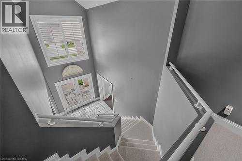 Foyer with a double glass-panel door, transom window, and white plantation shutters - 44 St Andrew'S Drive, Brantford, ON - Indoor Photo Showing Other Room