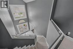 Foyer with a double glass-panel door, transom window, and white plantation shutters - 