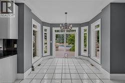 Bay window area featuring white tile flooring, gray walls, and white trim - 