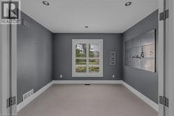 Room with gray walls, light carpet, and recessed lighting - 